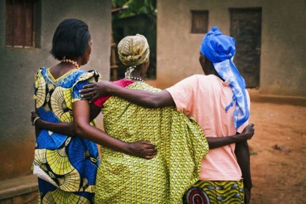 Rwandan women widow survivors hugging